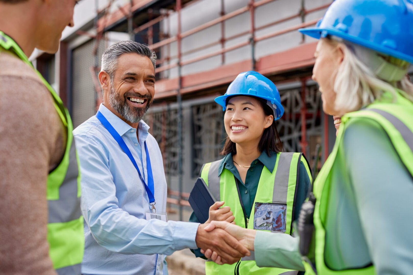 Construction worker shaking hands with foreman Construction workers and manager shaking hands.